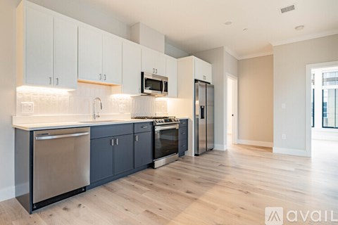 A kitchen with wooden floors and white walls.
