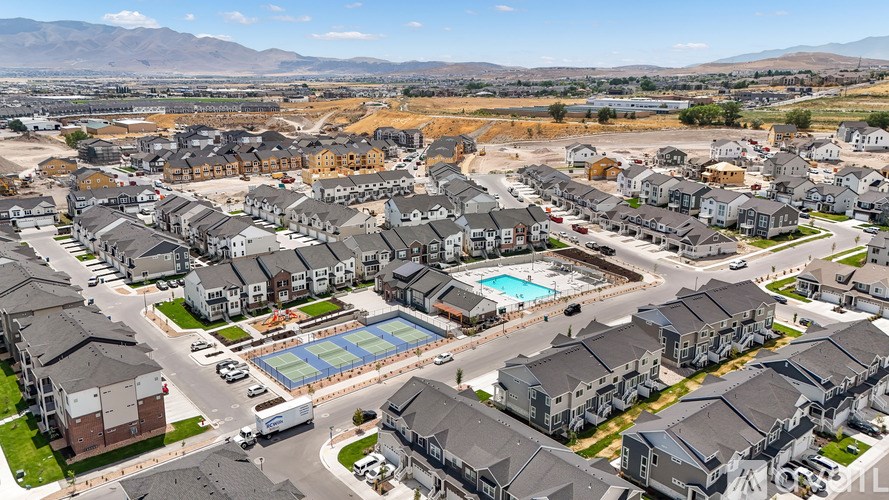 A large residential area with a swimming pool and a road.