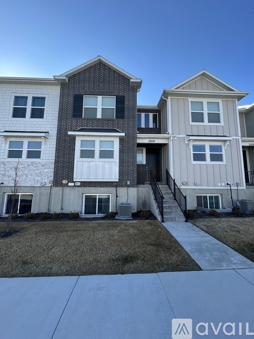 A row of houses with the middle one being the largest.