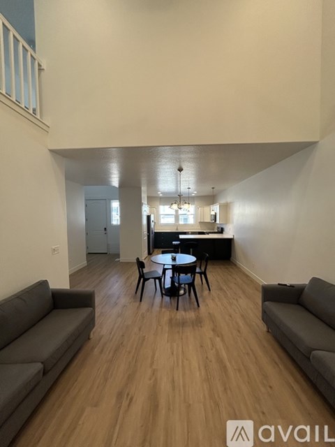 A living room with a grey couch and a black table.