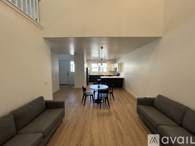 A living room with a grey couch and a black table.