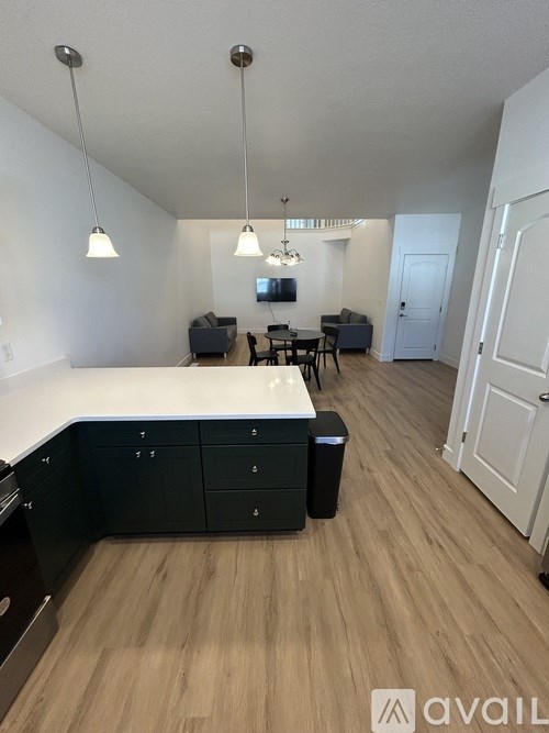 A kitchen with black cabinets and a white countertop.