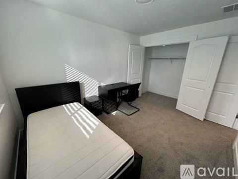 A bedroom with a bed, dresser, and closet.