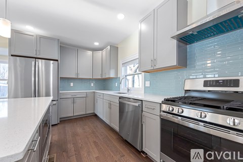 A kitchen with a stove top oven and a refrigerator.