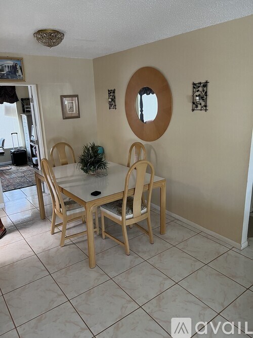 A dining room with a table and chairs.