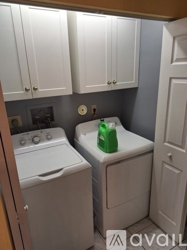 A small laundry room with a washer and dryer.