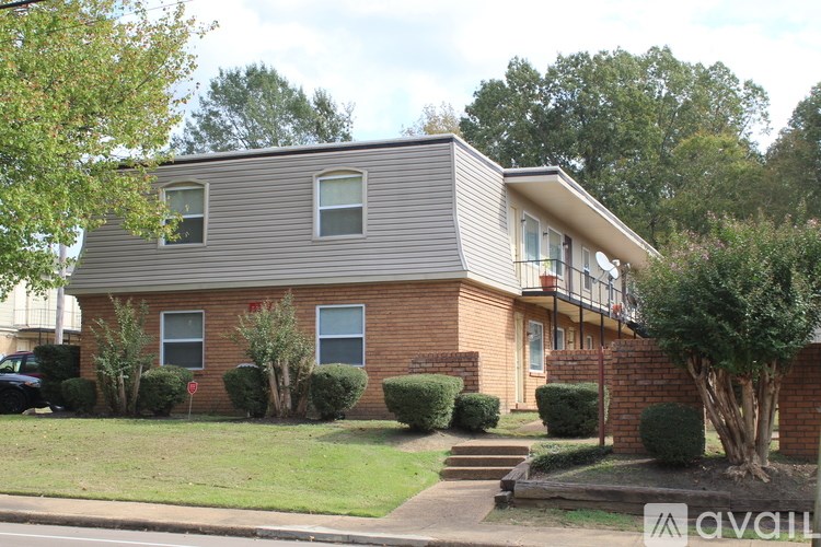 A house with a grey roof and a brick wall.