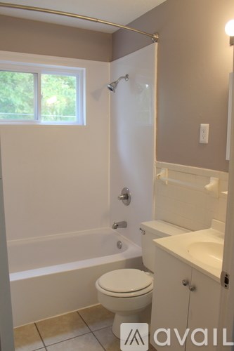 A bathroom with a toilet, sink, and bathtub.