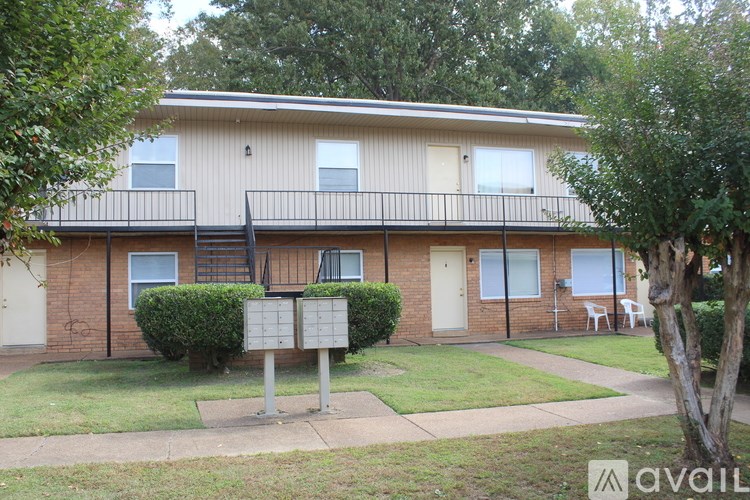A two-story apartment building with a balcony on the second floor.