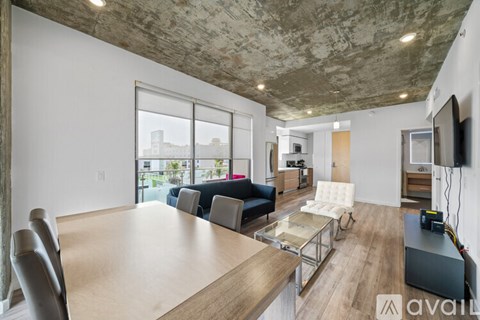 A modern living room with a large table and chairs.