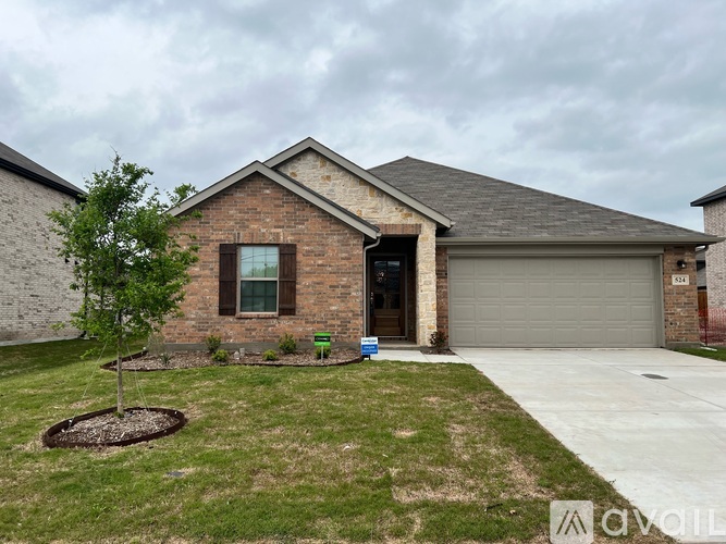 A house with a grey garage door and a brick exterior.