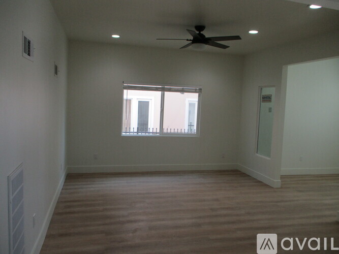 A room with a ceiling fan and a window.