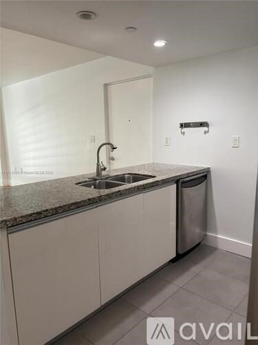 A kitchen with a sink and a counter.