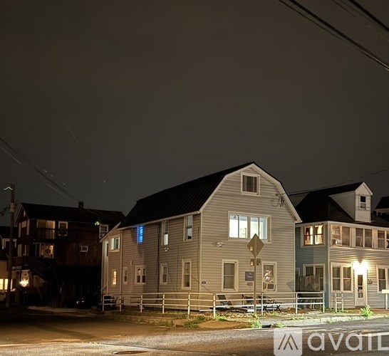A row of houses with lit up windows at night.
