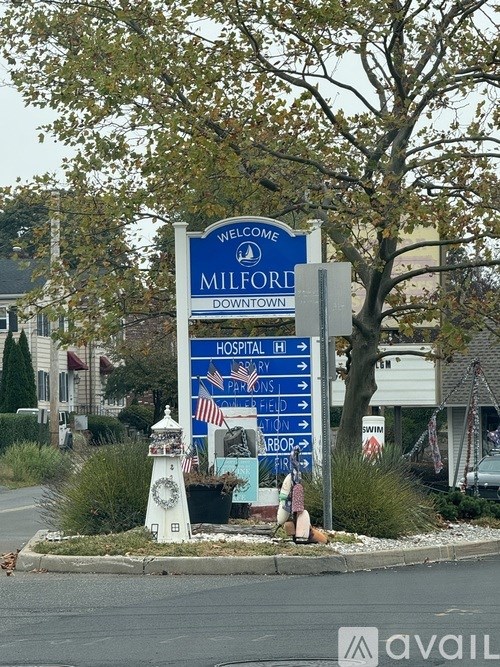 A sign welcoming people to Milford with a hospital and park nearby.