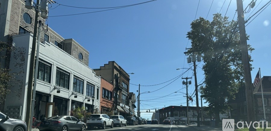 A street view of a town with cars parked on the side of the road.