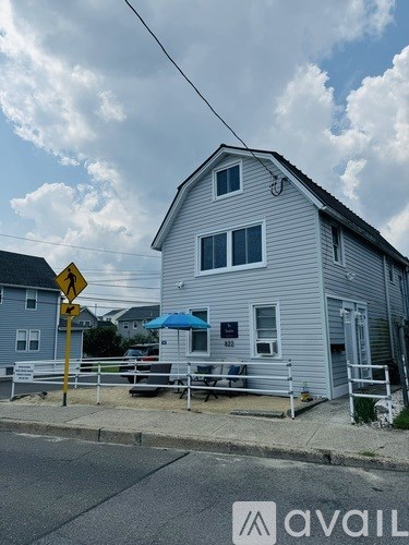 A house with a blue umbrella is for sale.