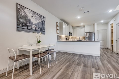 A modern kitchen with a dining table and chairs.