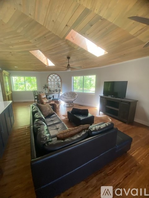 A living room with a long couch and a television.