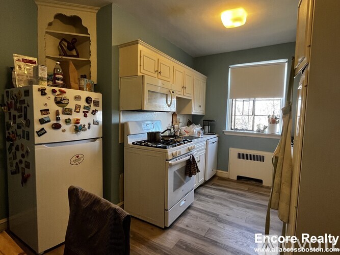 A kitchen with a white fridge and a white stove.
