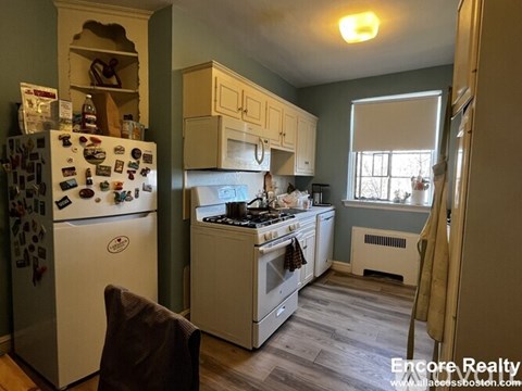A kitchen with a white fridge and a white stove.