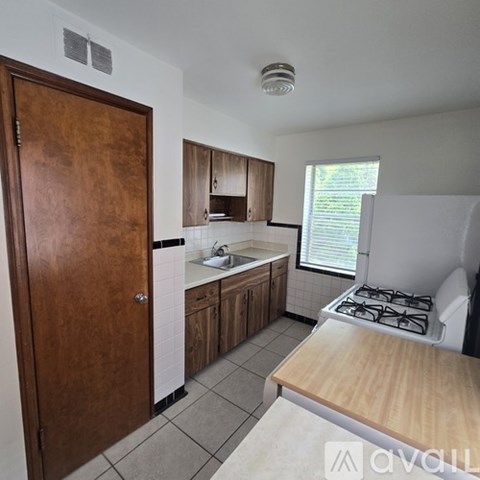 A room with wooden flooring and a ceiling fan.