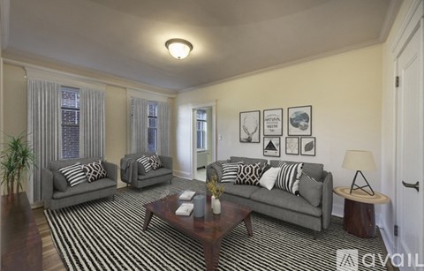 A living room with two grey couches and a coffee table.