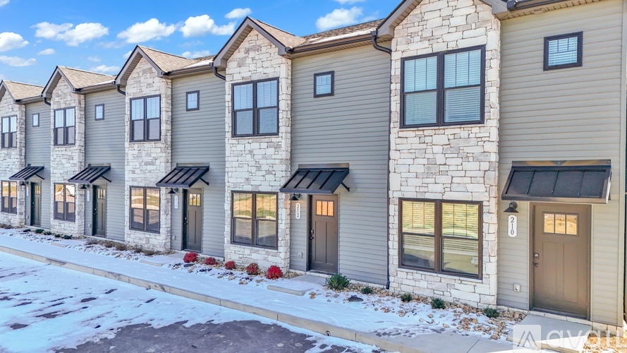 A row of houses with snow on the ground.