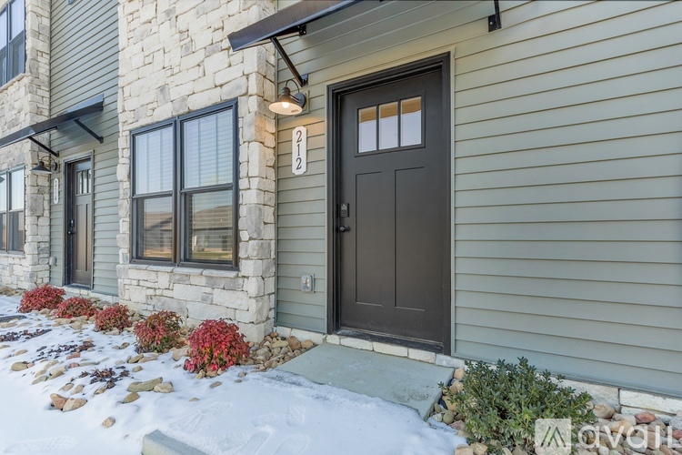 A house with a brown door and a number 12 above it.