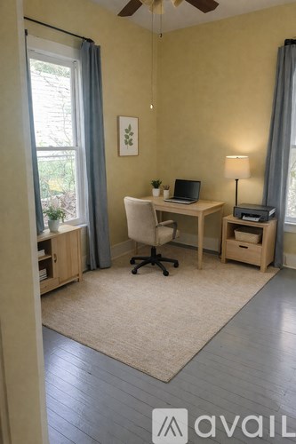 A kitchen with a trash can in the middle of the room.