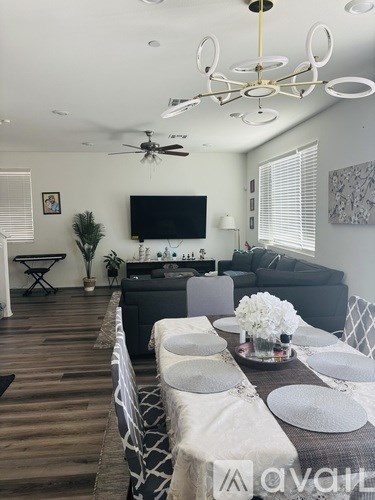 A dining room with a table set for a meal.