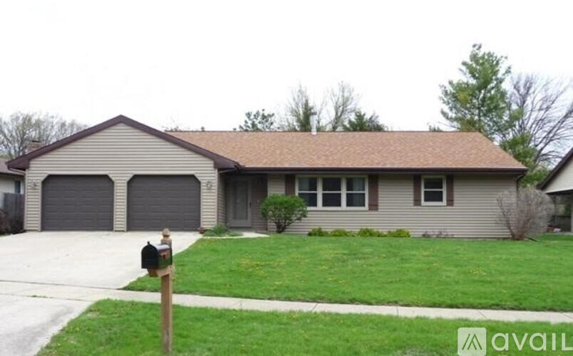 A house with a brown roof and grey garage doors.