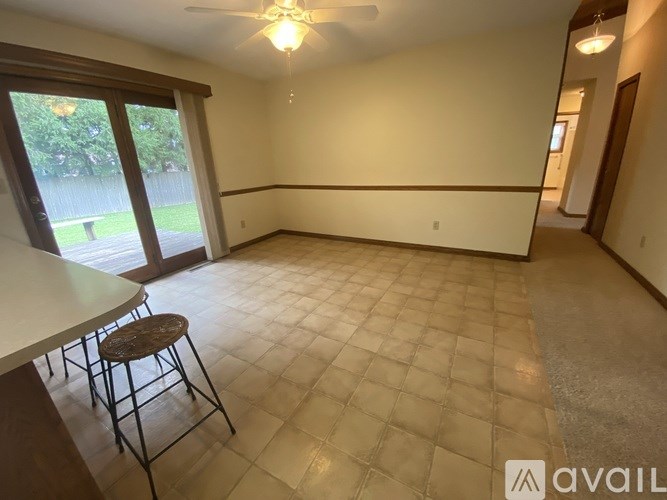 A room with a table and chairs and a window.