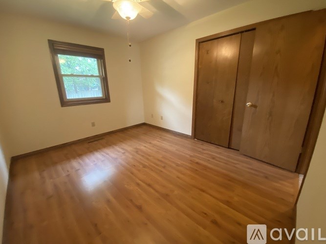 A room with wooden floors and a window.