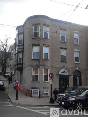 A street view of a building with a police officer standing outside.