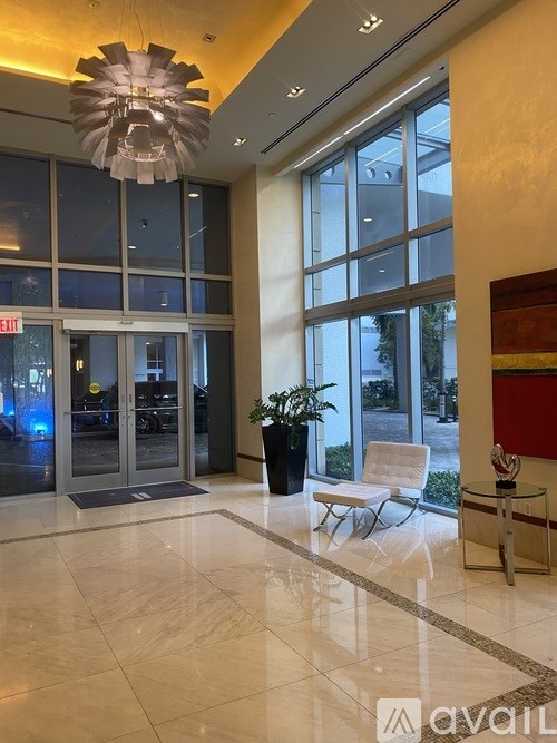 A large glass door with an exit sign above it.