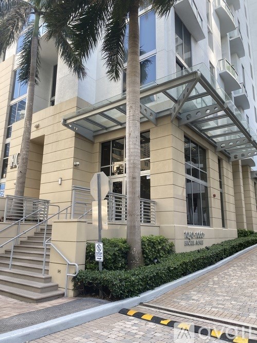 A building with a palm tree in front of it.