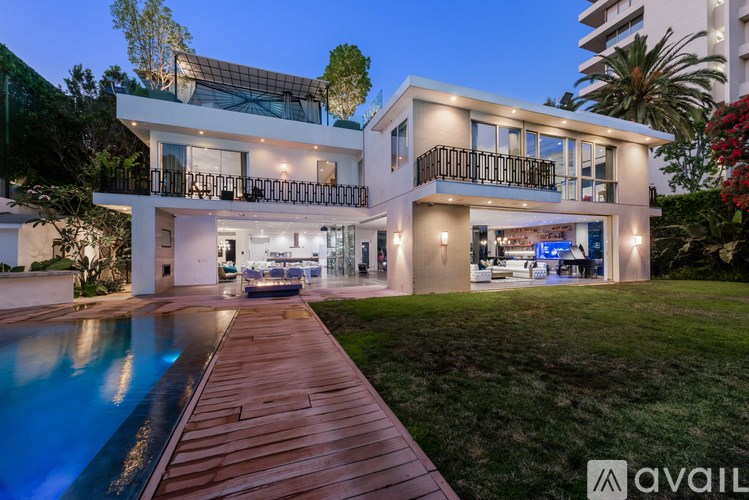 A modern house with a pool in the backyard.