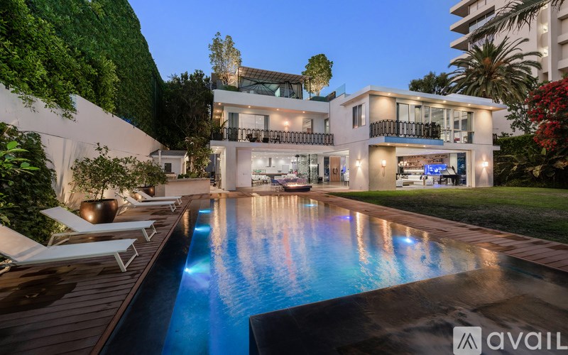 A modern house with a pool in the backyard.