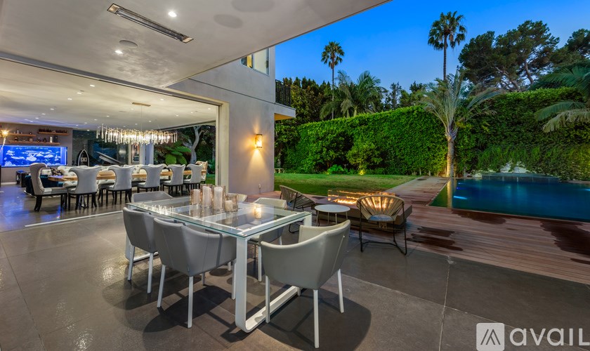 A modern dining area with a pool in the backyard.