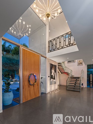 A modern interior with a wooden door and a staircase.