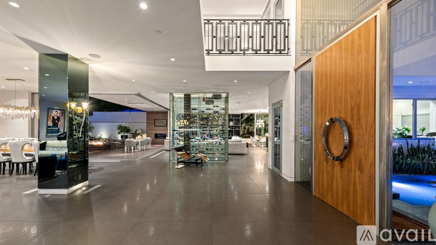 A modern interior with a glass wall and a wooden door.