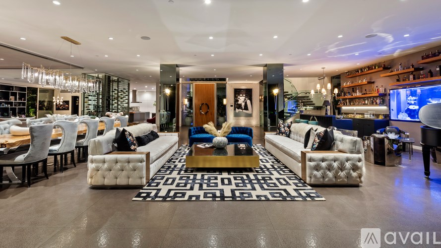 A modern living room with a large rug and a piano.