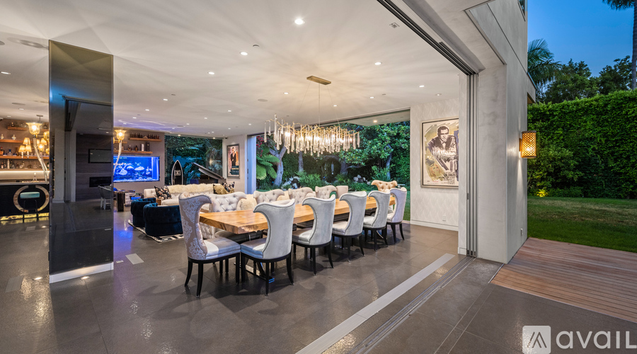 A modern dining room with a long table set for a meal.