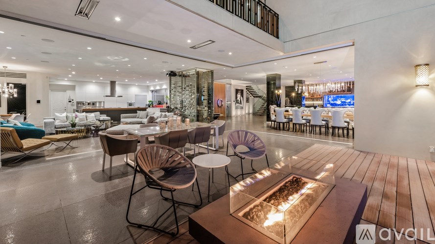 A modern living room with a wooden floor and a variety of seating options.