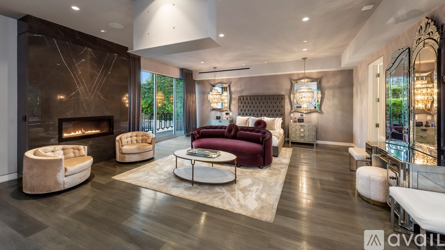 A modern living room with a fireplace and a large mirror on the wall.