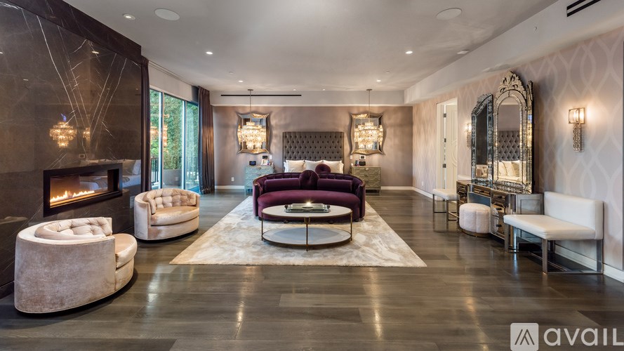 A modern living room with a fireplace and a large mirror on the wall.