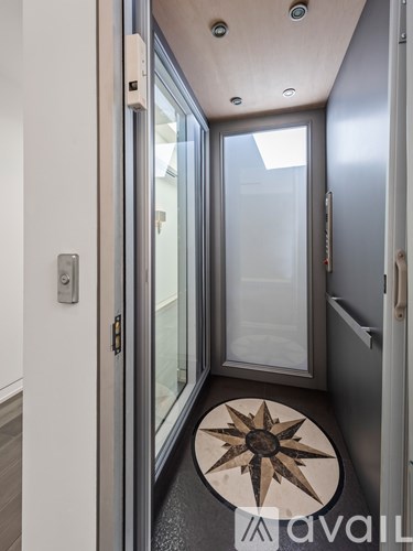 A hallway with a wooden floor and a compass design on the floor.