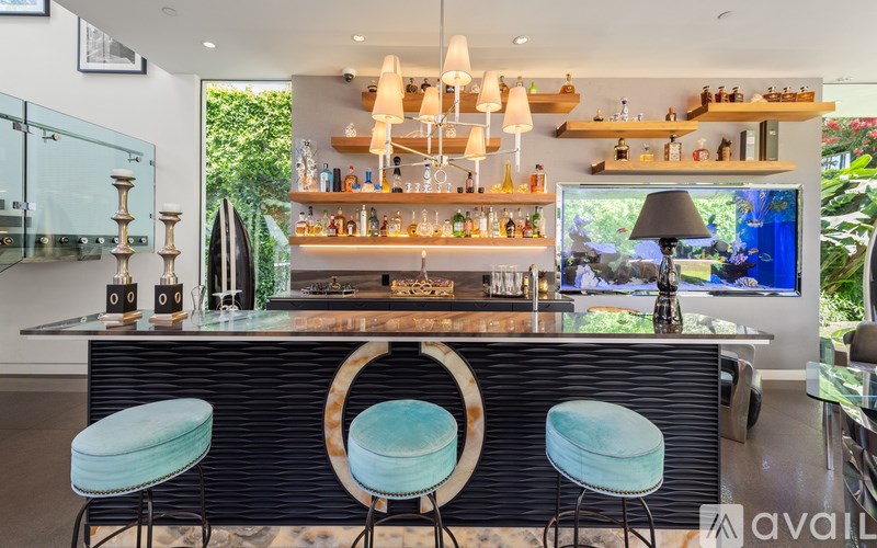 A bar with two stools in front of it.