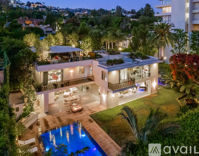 A modern house with a pool at night.
